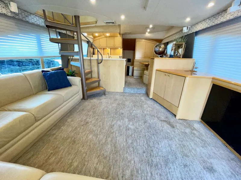 Slide: The Image of Luxurious interior of a 2003 Ocean Yachts 62 Convertible with modern furnishings and spiral staircase. - 7