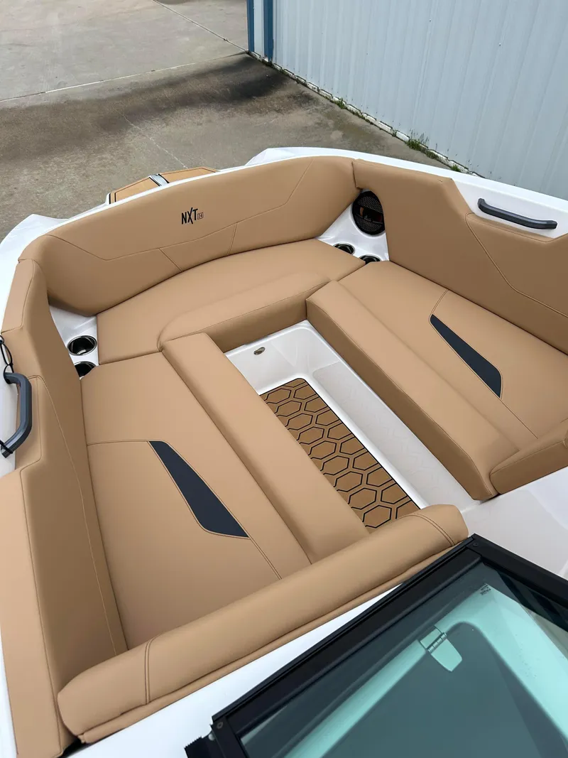 Slide: The Image of 2024 MasterCraft NXT 24 boat with tan seating and modern design. - 10