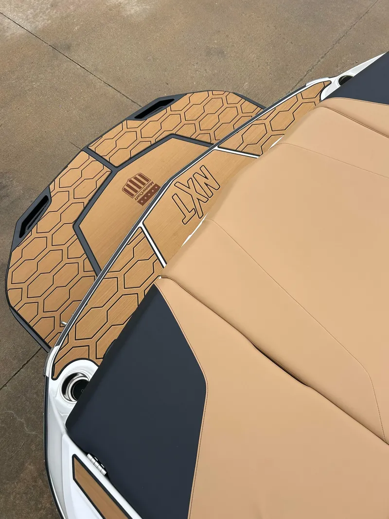 Slide: The Image of 2024 MasterCraft NXT 24 boat with tan and black seating. - 4