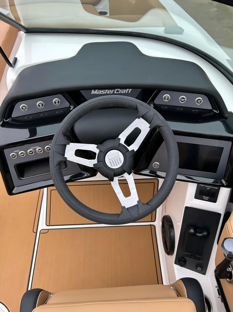 Slide: The Image of 2024 MasterCraft NXT 24 boat dashboard with steering wheel and control panel. - 9