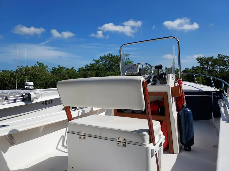 Slide: The Image of 2000 Eastern 19 Center Console boat with white seating and clear blue sky. - 10