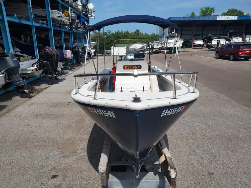 Slide: The Image of 2000 Eastern 19 Center Console boat in marina storage, blue hull, with canopy. - 13