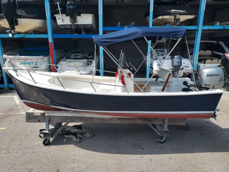 Slide: The Image of 2000 Eastern 19 Center Console boat in storage facility. - 14