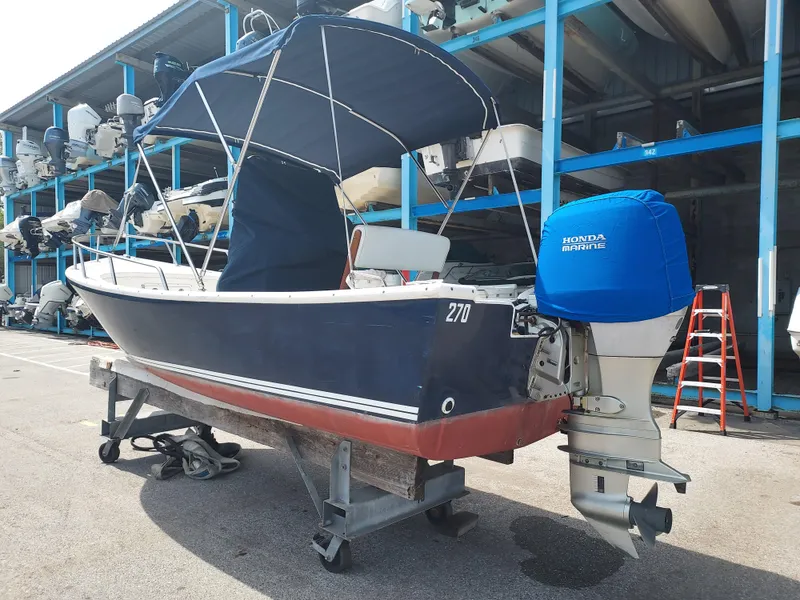 Slide: The Image of 2000 Eastern 19 Center Console boat with Honda Marine outboard motor in storage. - 17