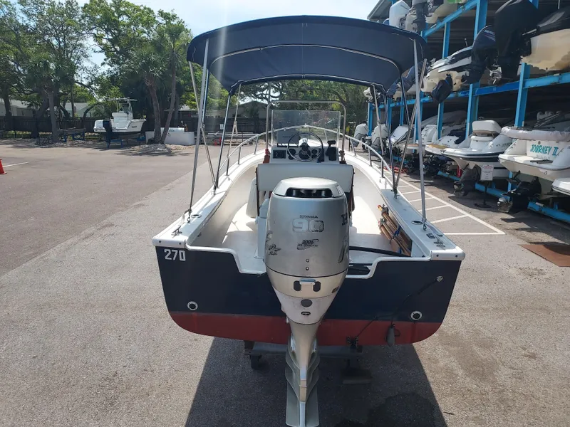 Slide: The Image of 2000 Eastern 19 Center Console boat with Honda 90 outboard motor in marina. - 19