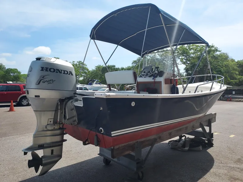 Slide: The Image of 2000 Eastern 19 Center Console boat with Honda outboard motor on trailer. - 27