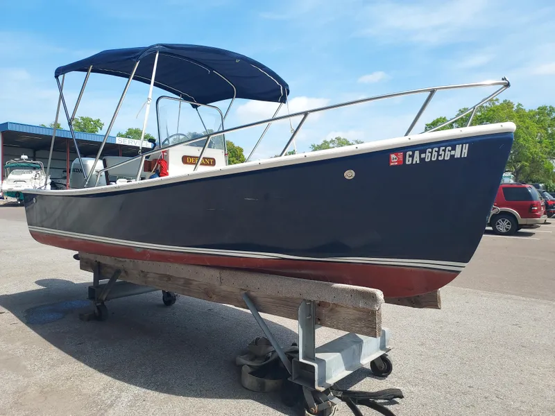 Slide: The Image of 2000 Eastern 19 Center Console boat on trailer in a service yard. - 29