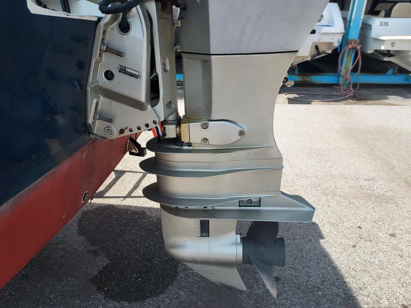 Slide: The Image of Close-up of the outboard motor on a 2000 Eastern 19 Center Console boat. - 36