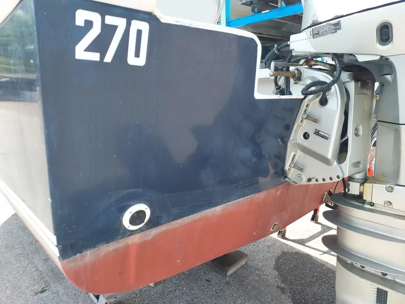 Slide: The Image of Close-up of a 2000 Eastern 19 Center Console boat's stern and outboard motor. - 37