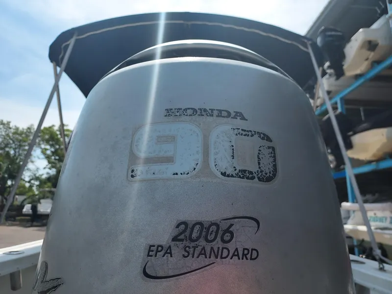 Slide: The Image of Close-up of a Honda 90 outboard motor on a 2000 Eastern 19 Center Console boat. - 39
