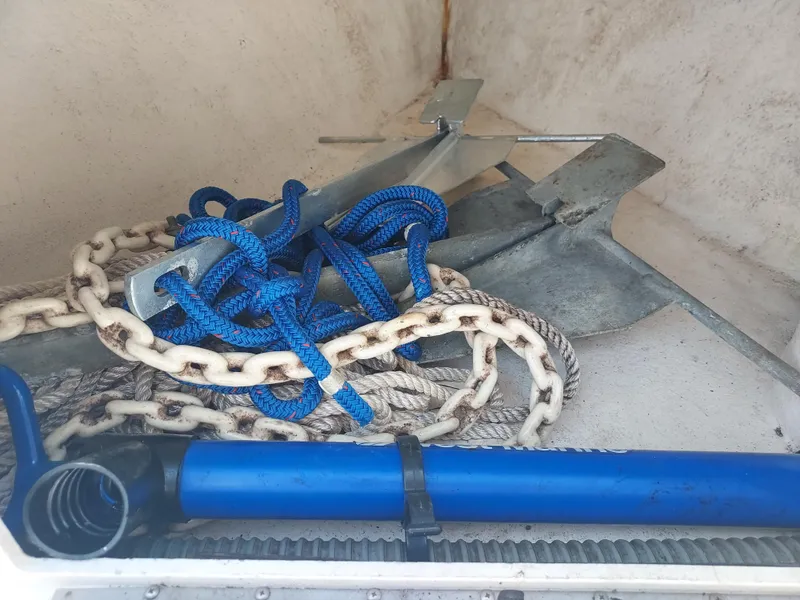Slide: The Image of Boat storage compartment with anchor, blue rope, and chain on a 2000 Eastern 19 Center Console. - 45