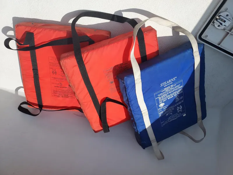 Slide: The Image of Three life jackets on a 2000 Eastern 19 Center Console boat. - 49