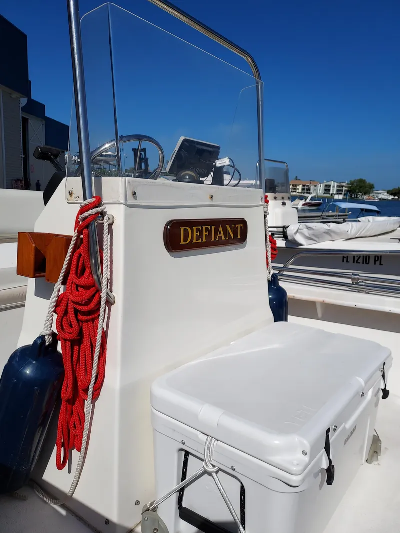 Slide: The Image of 2000 Eastern 19 Center Console boat named Defiant with red ropes and cooler. - 7