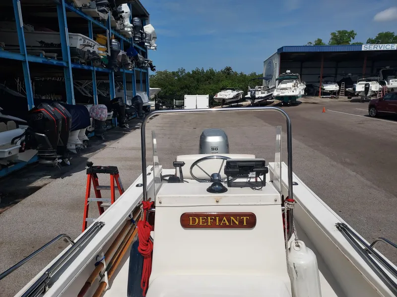 Slide: The Image of 2000 Eastern 19 Center Console boat named Defiant at a marina service area. - 8
