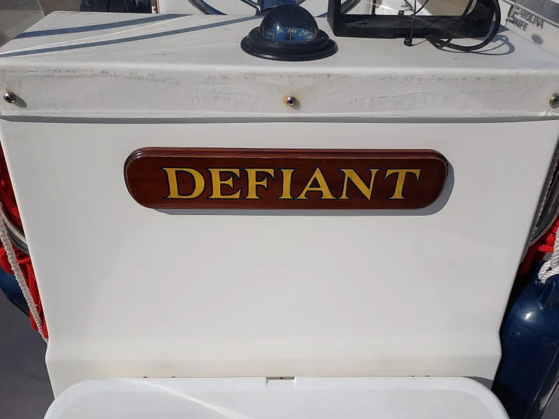 Slide: The Image of Eastern 19 Center Console 2000 boat named Defiant with compass and equipment. - 9