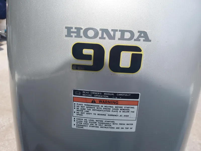 Slide: The Image of Close-up of Honda 90 outboard motor on 2000 Eastern 19 Center Console boat. - 11