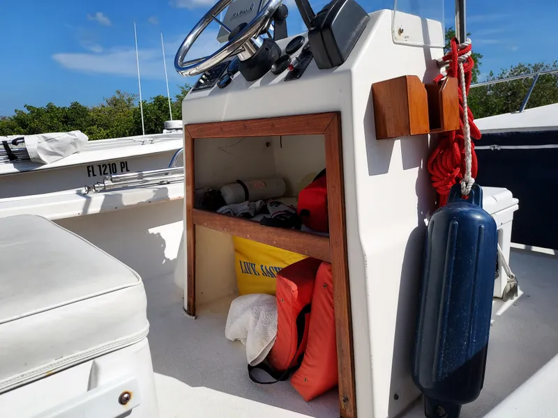 Slide: The Image of Center console of a 2000 Eastern 19 boat with storage and safety equipment. - 12