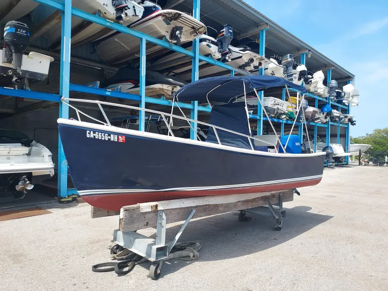 Slide: The Image of 2000 Eastern 19 Center Console boat in storage facility. - 15