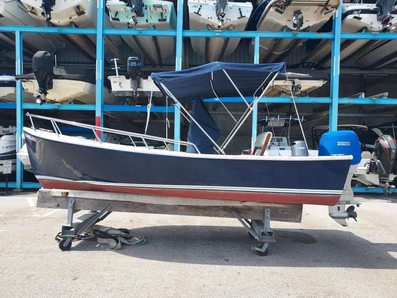 Slide: The Image of 2000 Eastern 19 Center Console boat in storage facility. - 16