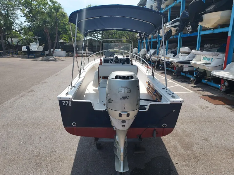 Slide: The Image of 2000 Eastern 19 Center Console boat with Honda 90 outboard motor in marina. - 18