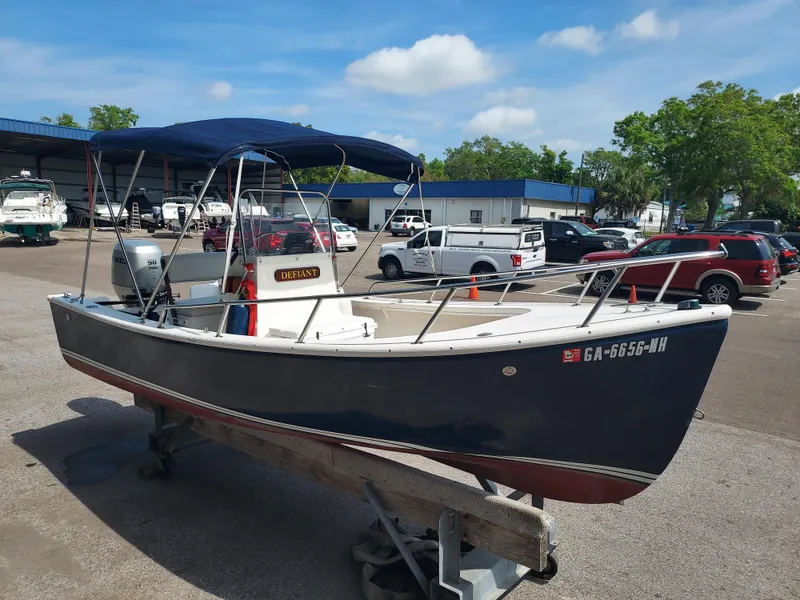 Slide: The Image of 2000 Eastern 19 Center Console boat in a marina parking lot. - 21