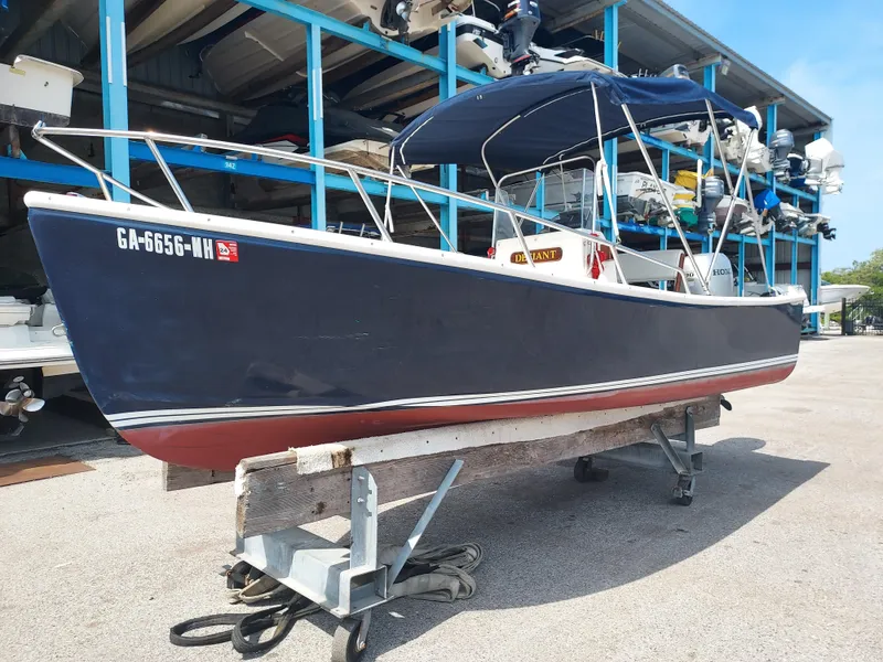 Slide: The Image of 2000 Eastern 19 Center Console boat on a trailer in a marina storage area. - 23