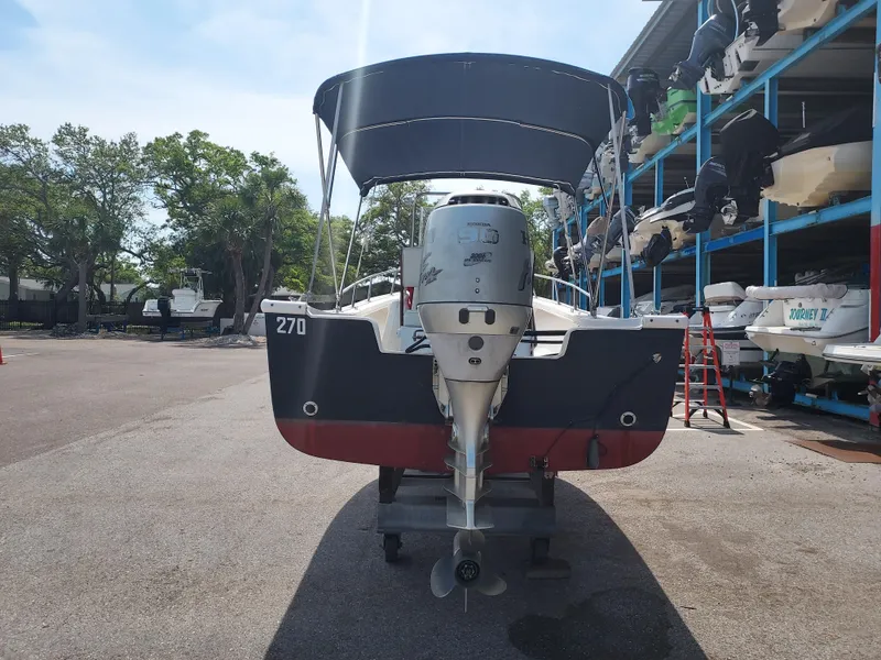 Slide: The Image of Eastern 19 Center Console 2000 boat with Honda outboard motor in storage facility. - 26