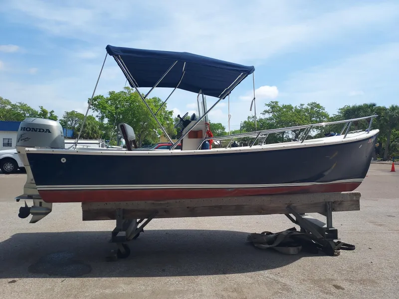 Slide: The Image of 2000 Eastern 19 Center Console boat with Honda outboard motor on a trailer. - 28