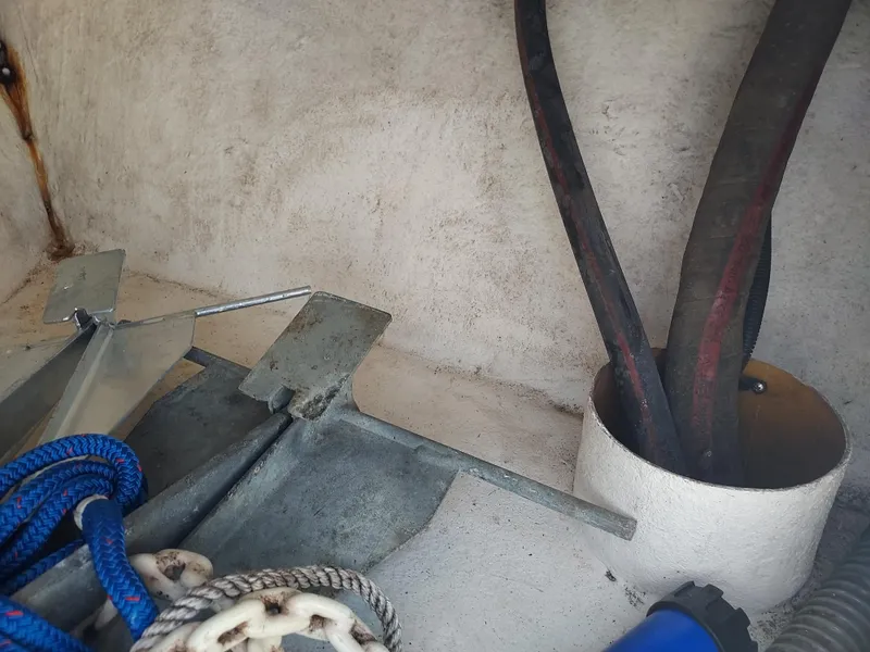 Slide: The Image of Boat storage compartment with anchor, ropes, and hoses on a 2000 Eastern 19 Center Console. - 47