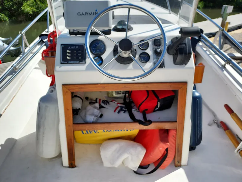 Slide: The Image of Center console of a 2000 Eastern 19 boat with Garmin GPS and safety gear. - 5