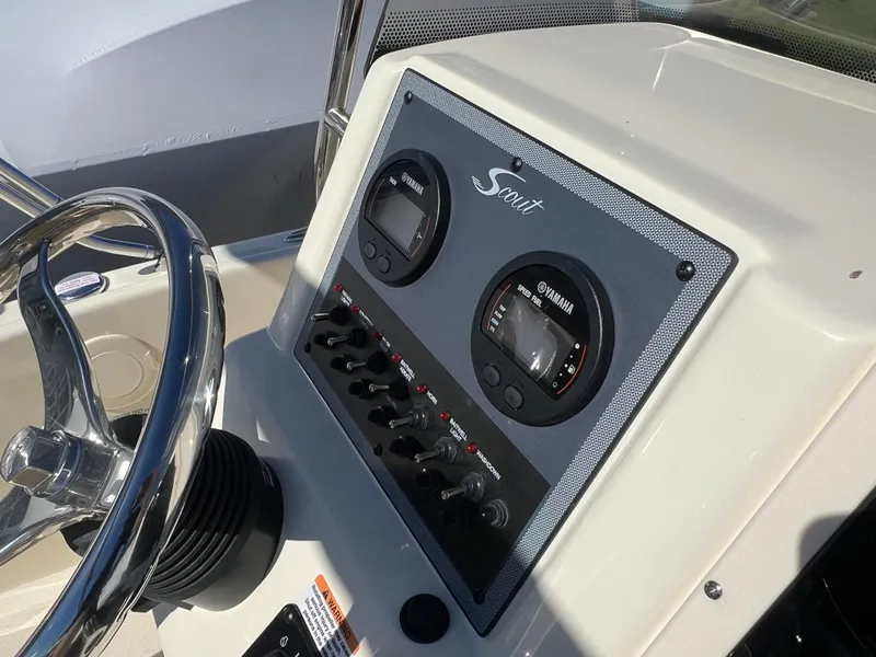 Slide: The Image of 2024 Scout 175 Sportfish dashboard with Yamaha gauges and control switches. - 10