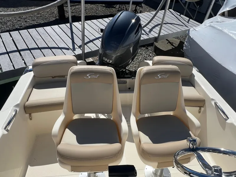 Slide: The Image of 2024 Scout 175 Sportfish boat with dual seats and outboard motor. - 11