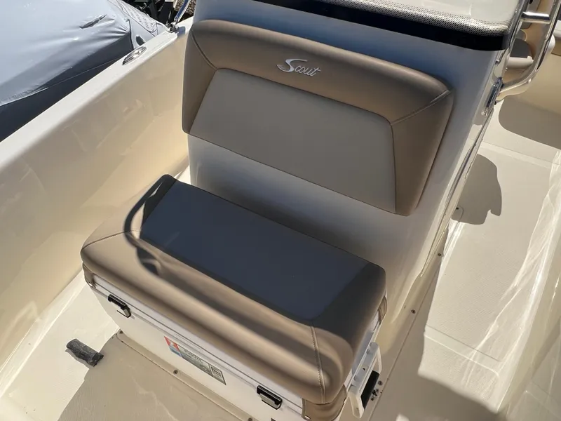 Slide: The Image of 2024 Scout 175 Sportfish boat seat with tan upholstery and storage compartment. - 13