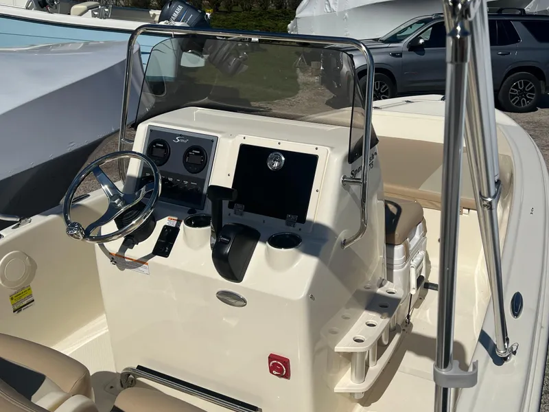 Slide: The Image of 2024 Scout 175 Sportfish boat console with steering wheel and navigation controls. - 6