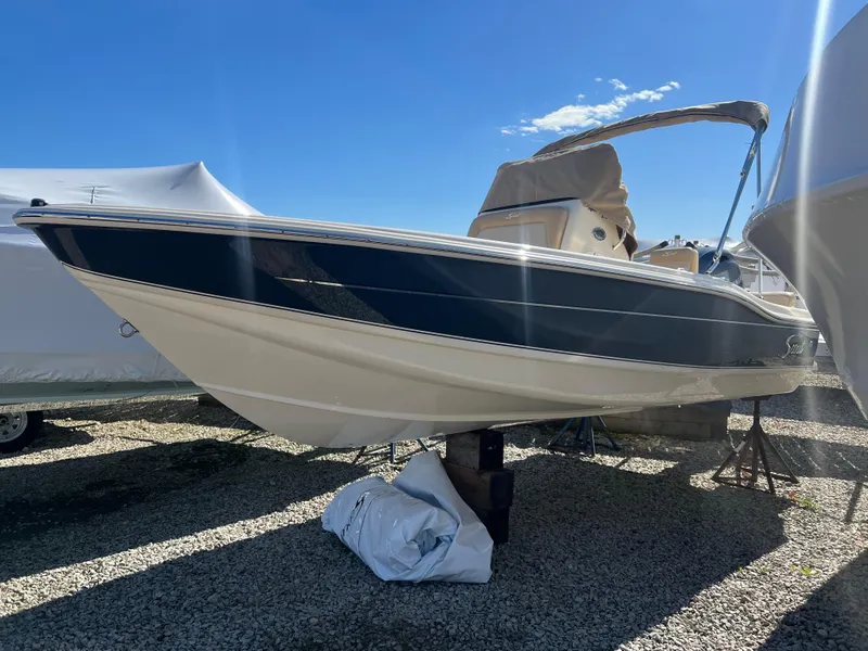 Slide: The Image of 2024 Scout 175 Sportfish boat on display under clear blue sky. - 9