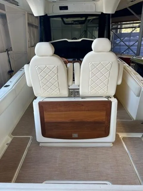 Slide: The Image of 2020 Chris-Craft Catalina 30 boat interior with white leather seats and wooden accents. - 10