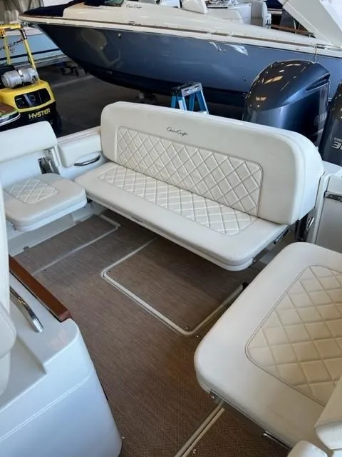 Slide: The Image of 2020 Chris-Craft Catalina 30 interior with white quilted seating and beige flooring. - 12