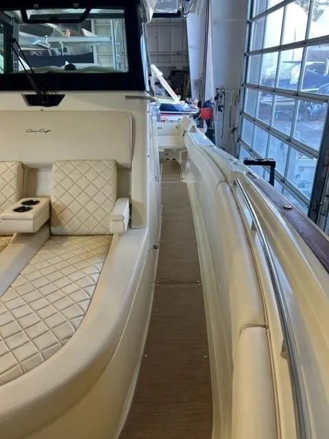 Slide: The Image of 2020 Chris-Craft Catalina 30 boat interior with beige seating and diamond stitching. - 19