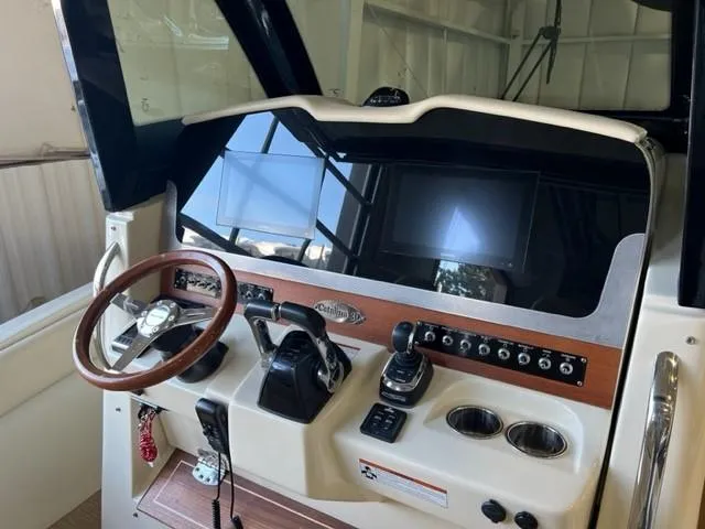 Slide: The Image of Helm of 2020 Chris-Craft Catalina 30 with steering wheel and control panel. - 22
