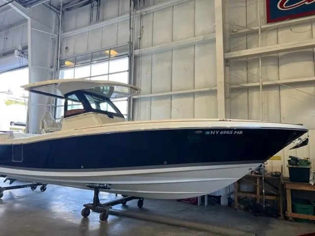 Slide: The Image of 2020 Chris-Craft Catalina 30 boat in a warehouse, side view. - 8