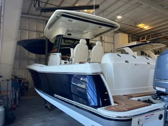 Slide: The Image of 2020 Chris-Craft Catalina 30 boat in indoor storage, rear view. - 9