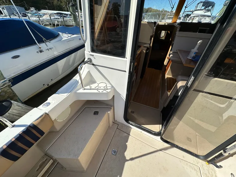 Slide: The Image of 2013 Cutwater 26 Coupe boat interior and deck area at marina. - 14