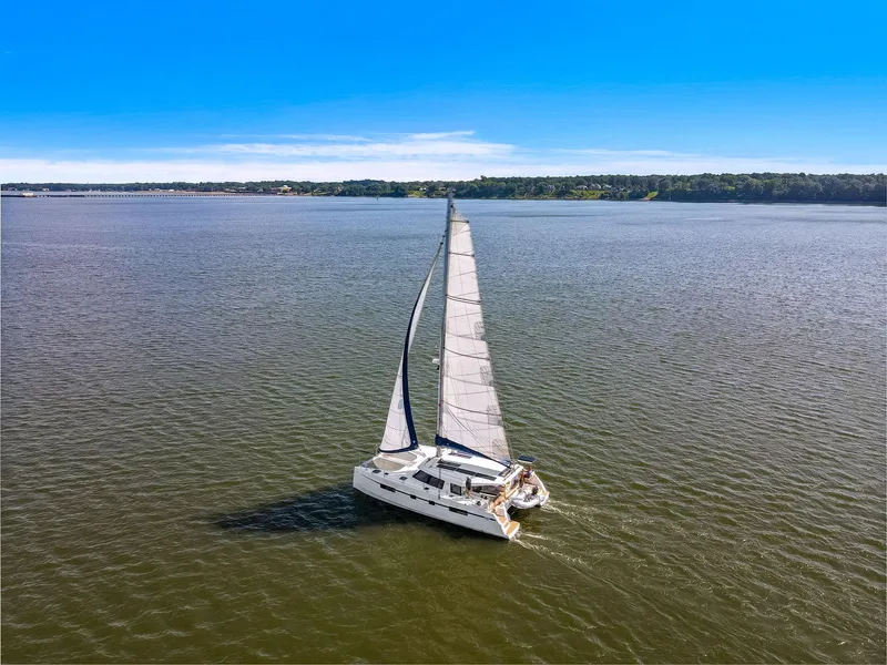 Slide: The Image of Sailing catamaran Nautitech 46 Open, 2017 model, cruising on open water under clear blue skies. - 13