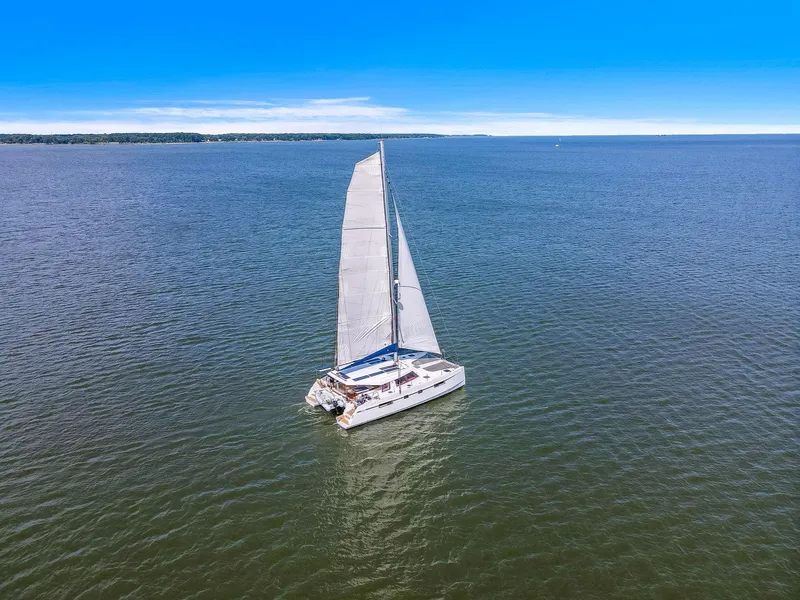 Slide: The Image of Sailing catamaran Nautitech 46 Open 2017 on open water under clear blue sky. - 15