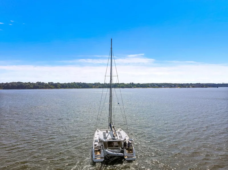 Slide: The Image of 2017 Nautitech 46 Open catamaran sailing on a calm lake under a clear blue sky. - 18