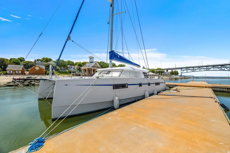 Slide: The Image of 2017 Nautitech 46 Open catamaran docked at a marina with clear blue skies. - 19