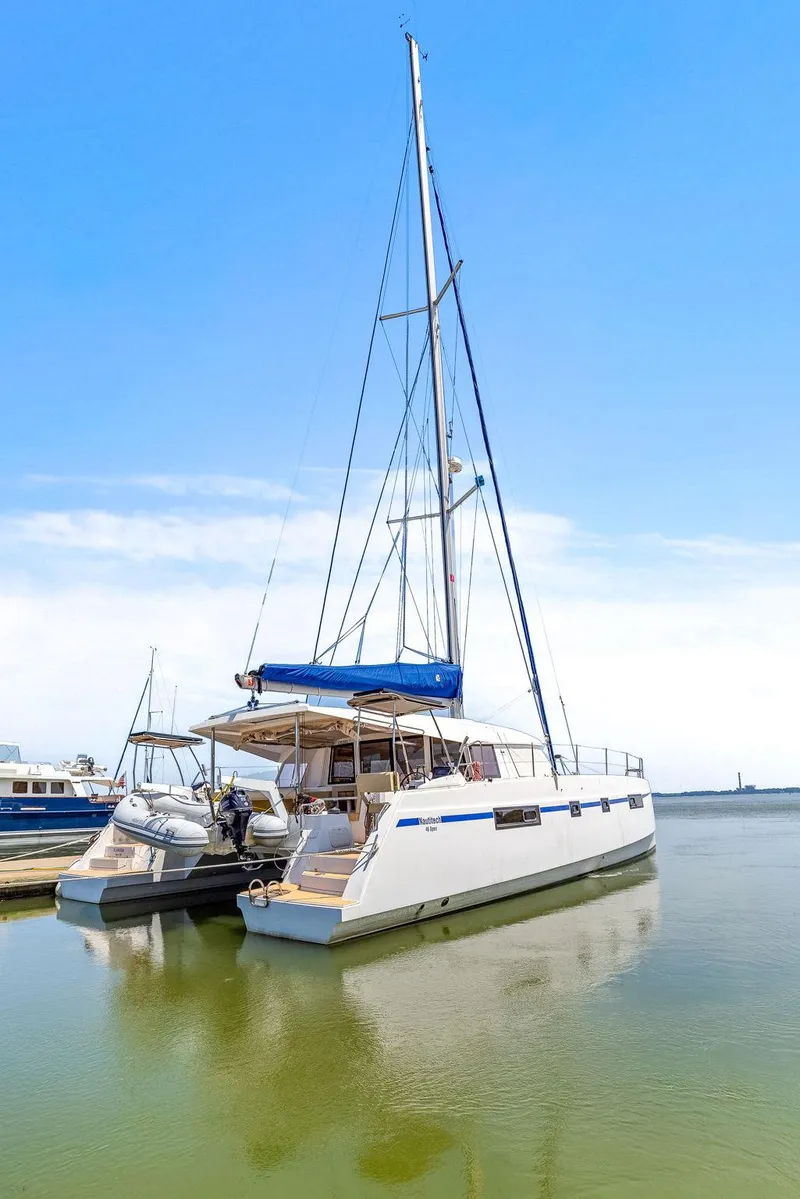 Slide: The Image of 2017 Nautitech 46 Open catamaran docked on calm water under clear blue sky. - 21