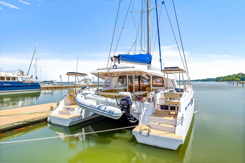 Slide: The Image of 2017 Nautitech 46 Open catamaran docked in a serene marina setting. - 24