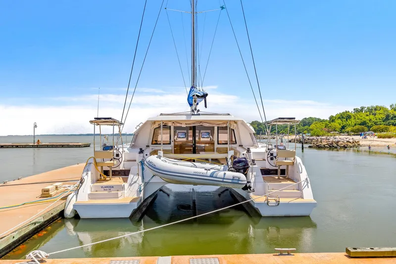 Slide: The Image of 2017 Nautitech 46 Open catamaran docked, featuring spacious deck and inflatable dinghy. - 26