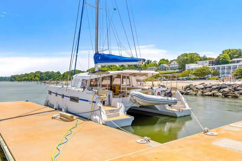 Slide: The Image of Nautitech 46 Open catamaran docked at a marina, 2017 model, with scenic waterfront view. - 27